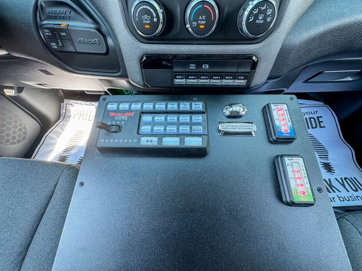 Console keypad close-up with emergency-light/siren controls.